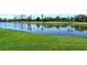 Gorgeous backyard view of a pond and golf course with lush green grass and trees at 5223 Chase Oaks Dr, Sarasota, FL 34241