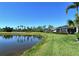 A relaxing backyard view of the pond, golf course, and screened-in lanai at 5223 Chase Oaks Dr, Sarasota, FL 34241