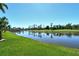 Panoramic view of the community lake and golf course beyond a manicured lawn at 5223 Chase Oaks Dr, Sarasota, FL 34241