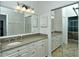 Bathroom with double sinks, granite countertop, and mirrored closet at 5223 Chase Oaks Dr, Sarasota, FL 34241