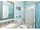 Bathroom with light blue striped wallpaper, vanity and shower/tub combination at 5223 Chase Oaks Dr, Sarasota, FL 34241