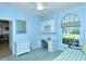 Bedroom with blue walls, daybed, desk, and a window with a view at 5223 Chase Oaks Dr, Sarasota, FL 34241