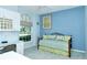 Bedroom with blue walls, daybed, and a window with a view at 5223 Chase Oaks Dr, Sarasota, FL 34241