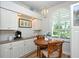 Bright breakfast nook featuring a round table, shuttered window, and built-in cabinets at 5223 Chase Oaks Dr, Sarasota, FL 34241
