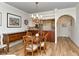 Open dining room and kitchen featuring a chandelier and light-colored wood floors at 5223 Chase Oaks Dr, Sarasota, FL 34241