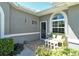Inviting entryway with tiled flooring, a bench, and a decorative window, enhancing the home's curb appeal at 5223 Chase Oaks Dr, Sarasota, FL 34241