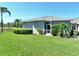 Charming home exterior with a well-maintained lawn, lush bushes, and screened-in lanai at 5223 Chase Oaks Dr, Sarasota, FL 34241