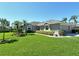 Charming gray home with lush green grass, trimmed bushes, and a well-maintained exterior at 5223 Chase Oaks Dr, Sarasota, FL 34241