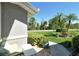 Cozy front porch with potted plants, comfortable seating, and a view of the landscaped yard at 5223 Chase Oaks Dr, Sarasota, FL 34241
