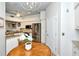 Eat-in kitchen with stainless steel appliances, wooden round table, and white cabinets at 5223 Chase Oaks Dr, Sarasota, FL 34241