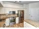 Well-lit kitchen with stainless appliances, granite counters and white cabinets at 5223 Chase Oaks Dr, Sarasota, FL 34241