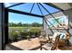 Enjoy the view of the lake and golf course from this covered and screened lanai with nice furniture at 5223 Chase Oaks Dr, Sarasota, FL 34241
