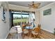 Enclosed lanai with a glass table and seating overlooking a golf course at 5223 Chase Oaks Dr, Sarasota, FL 34241