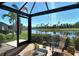 Screened lanai offers stunning views of the lake and lush landscaping beyond at 5223 Chase Oaks Dr, Sarasota, FL 34241