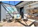 Relaxing screened-in lanai with comfortable seating and views to interior through sliding glass doors at 5223 Chase Oaks Dr, Sarasota, FL 34241