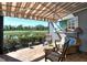Covered lanai with relaxing seating, beautiful lake view and retractable awning at 5223 Chase Oaks Dr, Sarasota, FL 34241