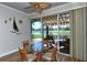 Enclosed lanai with a glass table and seating overlooking a lake at 5223 Chase Oaks Dr, Sarasota, FL 34241