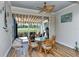 Enclosed lanai with a glass table and seating overlooking a lake at 5223 Chase Oaks Dr, Sarasota, FL 34241