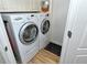Convenient laundry room features modern Bosch washer and dryer units at 5223 Chase Oaks Dr, Sarasota, FL 34241