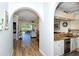 Open-concept living room with wood-look floors, an archway, and natural light flooding in from the sliding doors at 5223 Chase Oaks Dr, Sarasota, FL 34241