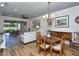 Bright living room with wood floors, a dining area, and a view of the outdoor golf course at 5223 Chase Oaks Dr, Sarasota, FL 34241