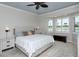Spacious main bedroom featuring a ceiling fan, bay window, and relaxing view at 5223 Chase Oaks Dr, Sarasota, FL 34241