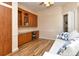 Bright office features hardwood floors, built-in desk and cabinets, and natural light at 5223 Chase Oaks Dr, Sarasota, FL 34241