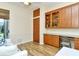 Office area with custom cabinets, granite countertop and a sliding door at 5223 Chase Oaks Dr, Sarasota, FL 34241