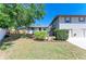 View of the back yard from the lawn, showing the raised deck and privacy fence at 5311 San Jose Dr, Sarasota, FL 34235