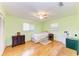 Bright bedroom featuring two windows, light green walls, ceiling fan, and hardwood flooring, creating a serene atmosphere at 5311 San Jose Dr, Sarasota, FL 34235