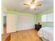 A spacious bedroom with hardwood flooring and a large closet, complemented by green walls and ample natural light at 5311 San Jose Dr, Sarasota, FL 34235
