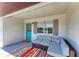 Charming front porch with colorful rug and comfortable seating at 5311 San Jose Dr, Sarasota, FL 34235