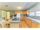 Bright kitchen featuring wood cabinets, a peninsula cooktop, and a view into an adjacent room from the dining table at 5311 San Jose Dr, Sarasota, FL 34235
