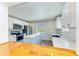 Modern kitchen with stainless steel appliances, white cabinets, center island, and wood flooring accents at 5311 San Jose Dr, Sarasota, FL 34235