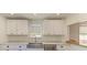 Bright kitchen features white cabinets, a stainless steel sink, and a sleek dishwasher for modern convenience at 5311 San Jose Dr, Sarasota, FL 34235