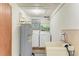 Utility room equipped with a water heater, laundry sink, and washer/dryer hookups, combining practicality with efficiency at 5311 San Jose Dr, Sarasota, FL 34235