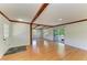 Bright living area boasts wood beam accents, seamlessly connecting to an outdoor deck through sliding glass doors at 5311 San Jose Dr, Sarasota, FL 34235