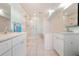 Bright bathroom featuring double sinks, a glass shower, and tiled flooring at 6263 Midnight Pass Rd # 301, Sarasota, FL 34242