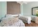 A light and airy bedroom features two twin beds, wood flooring, and a ceiling fan at 6263 Midnight Pass Rd # 301, Sarasota, FL 34242