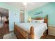 Inviting bedroom with beach decor, wood-look floors, and a comfortable wicker bed frame at 6263 Midnight Pass Rd # 301, Sarasota, FL 34242