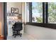 Cozy sunroom office features built-in bookshelves, a workspace with a desk, and a large window with natural lighting at 6263 Midnight Pass Rd # 301, Sarasota, FL 34242