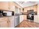 Bright kitchen featuring wood-look flooring, stainless steel appliances, and granite countertops at 6263 Midnight Pass Rd # 301, Sarasota, FL 34242