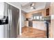 Bright and airy kitchen featuring stainless steel appliances, light wood cabinetry, granite countertops, and wood flooring at 6263 Midnight Pass Rd # 301, Sarasota, FL 34242