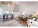 Bright living room featuring a spiral staircase, bar seating, comfortable sofas, and a large chandelier at 6263 Midnight Pass Rd # 301, Sarasota, FL 34242