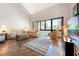 Bright living room with wood floors, comfortable furnishings, a large window providing ample natural light, and a cozy sunroom at 6263 Midnight Pass Rd # 301, Sarasota, FL 34242