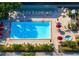Overhead view of a pristine community pool, complete with ample seating and lush landscaping at 6263 Midnight Pass Rd # 301, Sarasota, FL 34242