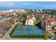 Aerial view featuring on-site tennis courts with players and nearby coastal residences at 6263 Midnight Pass Rd # 301, Sarasota, FL 34242