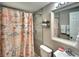 Cozy bathroom featuring a shower with nautical themed curtain and a gray tiled wall at 6434 5Th W St, Bradenton, FL 34207