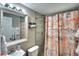 Stylish bathroom featuring modern fixtures, decorative shower curtain, and tiled walls at 6434 5Th W St, Bradenton, FL 34207