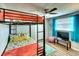 Colorful bedroom featuring a twin bunk bed with an orange comforter and a ceiling fan at 6434 5Th W St, Bradenton, FL 34207